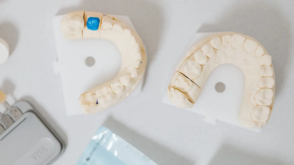 Close-up of dental molds on a white table, showcasing orthodontic details.