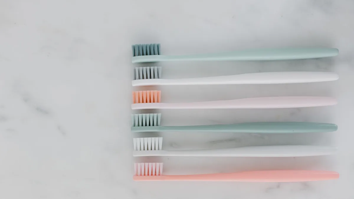 Minimalist arrangement of pastel toothbrushes on a marble surface, ideal for dental care themes.
