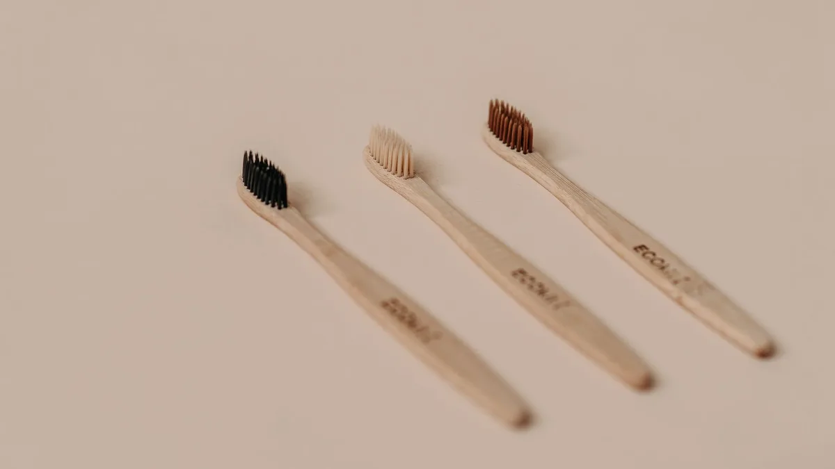 Set of eco-friendly bamboo toothbrushes on a neutral background.