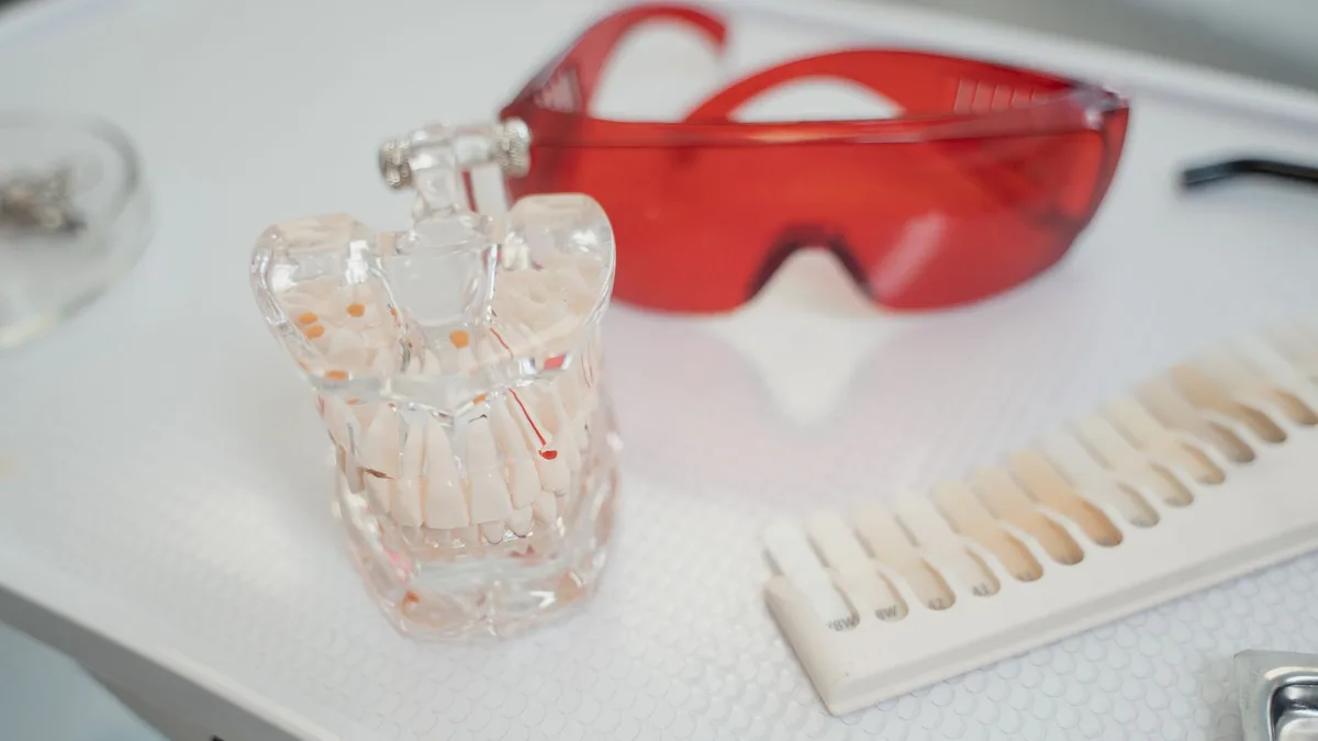 Dental cast, shade guide, and safety glasses on a clinical tray for dental procedures.