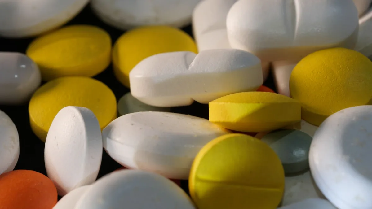 Close-up image of various colored tablets showcasing pharmaceutical diversity.