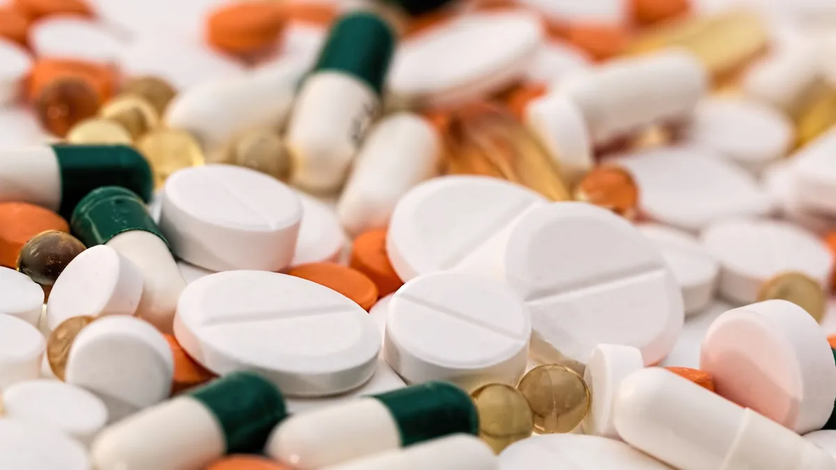 Close-up of various pills and capsules in different colors and sizes, ideal for healthcare-related content.